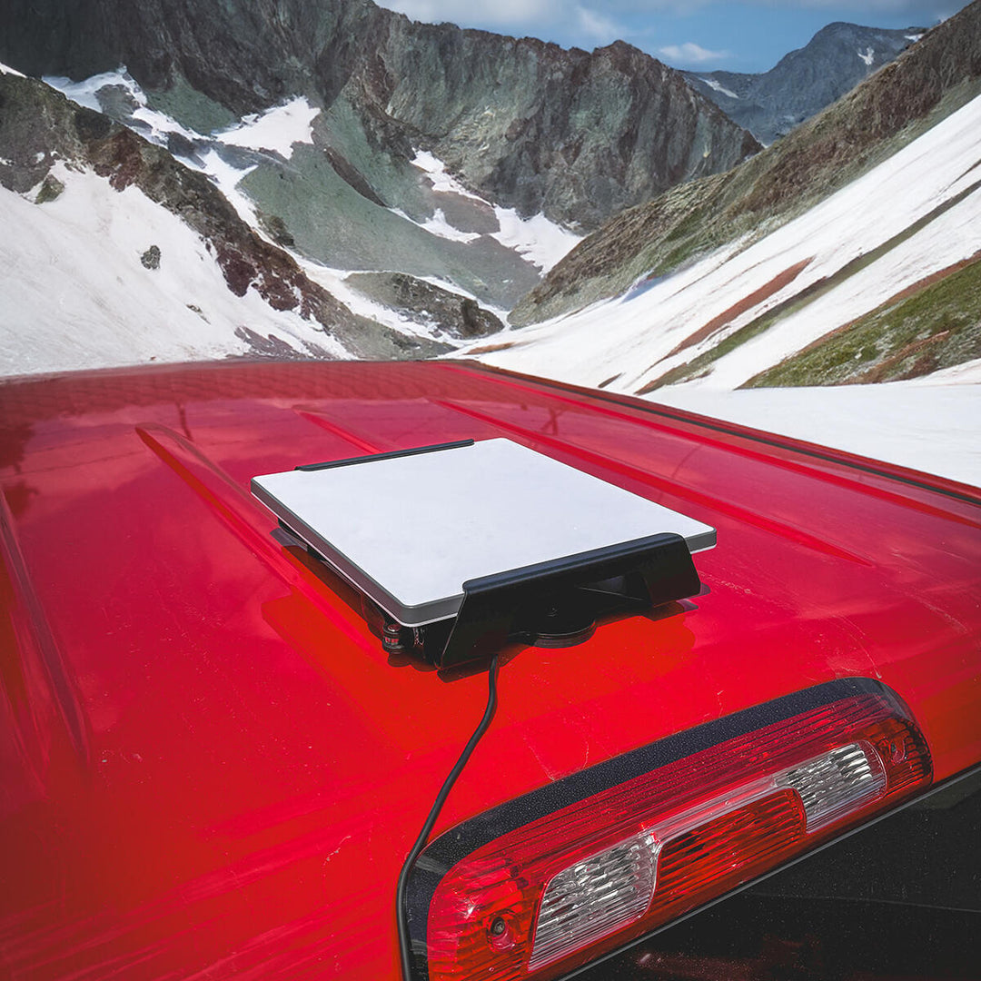 Starlink Mini on a magnetic mount on a red truck roof in the mountains